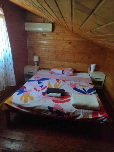 a bedroom with a bed in a wooden room at Kuća za odmor Giulitta in Porat