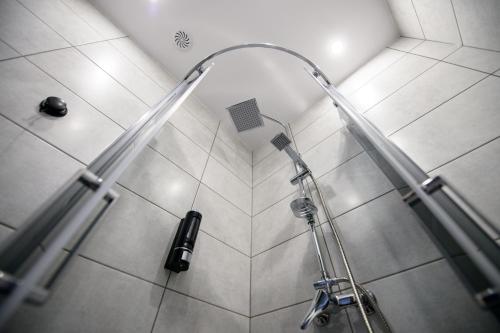 y baño con ducha con cabezal de ducha. en ONRest Hostel Centrum Żytnia 8, en Kielce