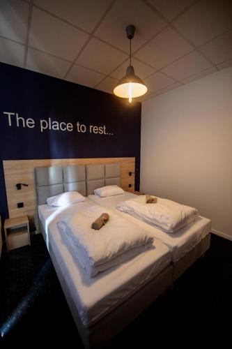 a bed with two dogs laying on top of it at ONRest Hostel Centrum Żytnia 8 FaktVat in Kielce