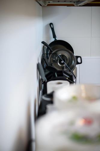 a pot is hanging on a wall in a kitchen at ONRest Hostel Centrum Żytnia 8 FaktVat in Kielce
