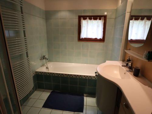 a bathroom with a tub and a sink at Chalet Arêches-Beaufort, 9 pièces, 10 personnes - FR-1-342-232 in Beaufort