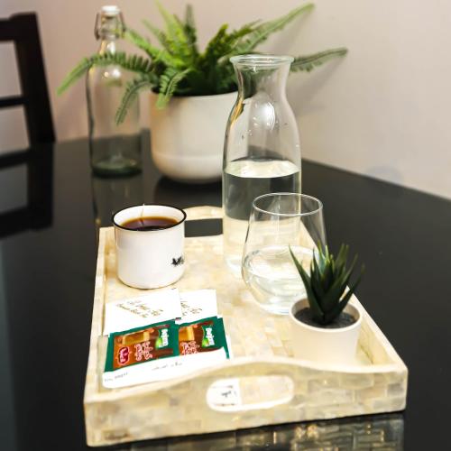 a table with a tray with a drink and a glass at NewCity Hotel & Suites in Cairo