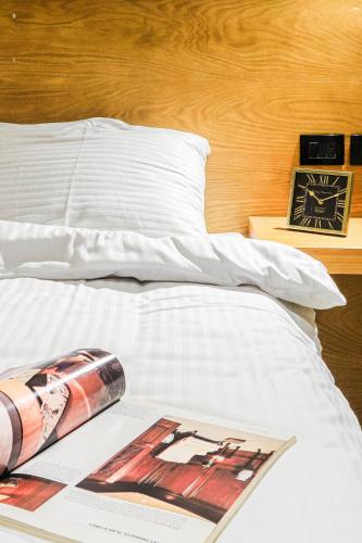a bed with a magazine on top of it at NewCity Hotel & Suites in Cairo