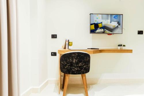 a desk with a black chair in a room at NewCity Hotel & Suites in Cairo