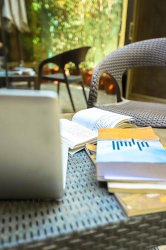 a laptop computer sitting on top of a table with books at NewCity Hotel & Suites in Cairo