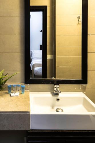 a bathroom sink with a large mirror above it at NewCity Hotel & Suites in Cairo