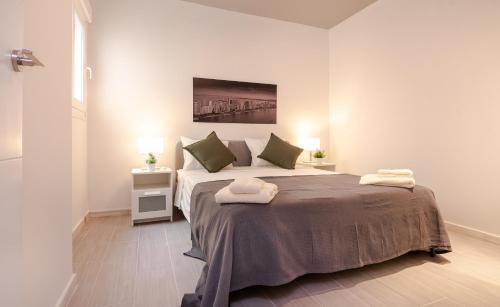 a bedroom with a bed with two towels on it at Apt w Beach/Mountain Views, Pool and Parking in Tarifa
