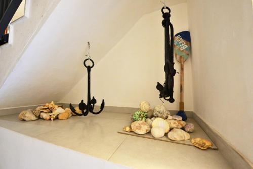 a bunch of vegetables sitting on the floor under a staircase at BEACHFRONT with Seaviews Apartment No56 Award Winner Unbeatable Location for Closeness to the Sea Ideal for Guests looking for Winter Spring and Autumn Breaks in Sunny Malta Also Ideal for Coastal Hikers in Mellieħa