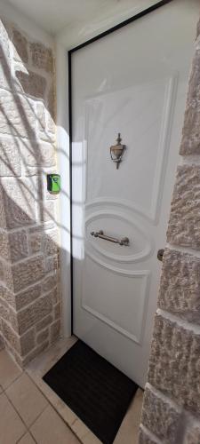 a white garage door with a handle on it at Stone House in olive grove in Tolo