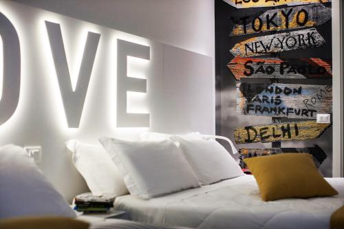 a white couch with white pillows in a room at Love Boat Hotel - The Original in Riccione