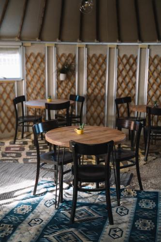 a dining room with wooden tables and chairs at Succah in the Desert in Mitzpe Ramon