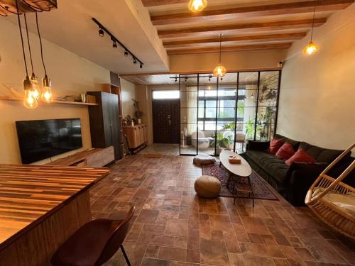 a living room with a couch and a table at Lily's House in Zhushan