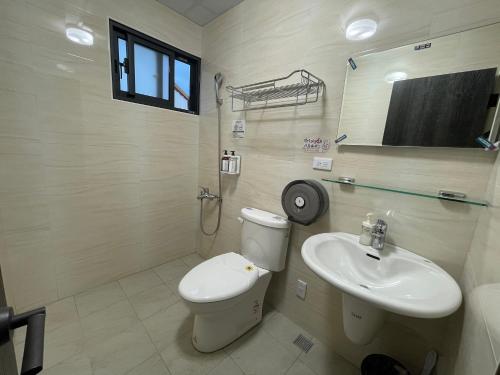 a bathroom with a toilet and a sink at Lily's House in Zhushan