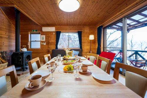 a dining room with a long table and chairs at Suite Villa Minami-Atamigaoka in Atami