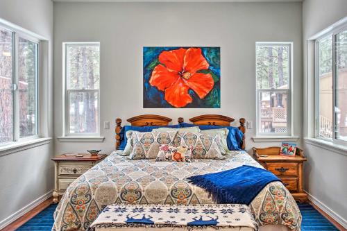 a bedroom with a bed with a flower painting on the wall at Flagstaff Family Retreat with Patio and Mountain Views in Mountainaire