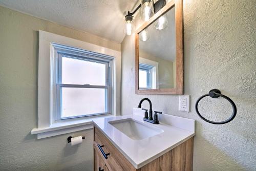 a bathroom with a sink and a mirror and a window at Bright Pittsburgh Apt, Walk to Grandview Ave! in Pittsburgh