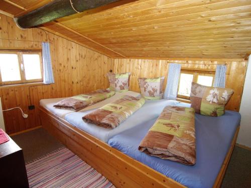a bedroom with two beds in a wooden cabin at Property in Hippach in Hippach