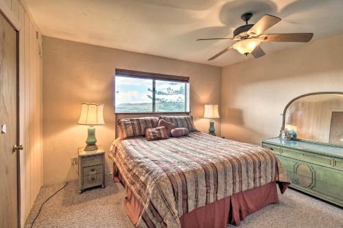 a bedroom with a bed and a ceiling fan at Peaceful Ranch Cabin, 3 Mi to Becker Lake! in Springerville