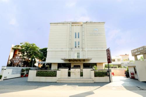 a white building with a sign in front of it at Royale Lalit Hotel Jaipur in Jaipur