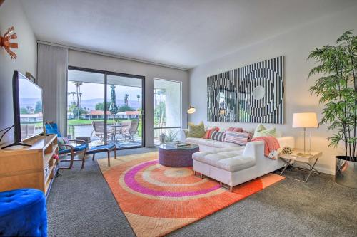 a living room with a couch and a table at Rancho Mirage Condo on Fairway with Resort Amenities! in Rancho Mirage