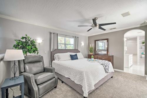 a bedroom with a bed and a chair and a ceiling fan at Crystal River Getaway with Hot Tub and Game Room! in Crystal River