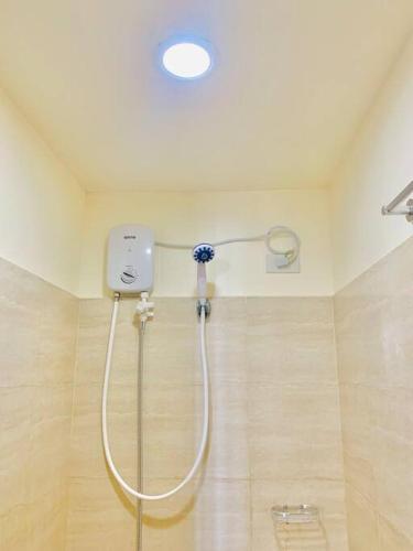 a shower in a bathroom with aitizer at Mabolo Garden Flats 2306 in Cebu City