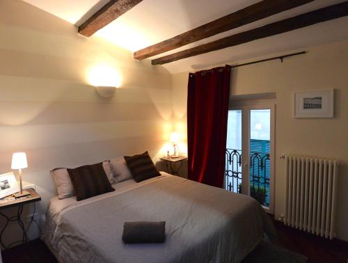 a bedroom with a large bed and a balcony at Appartamento dei Sassetti in Savona