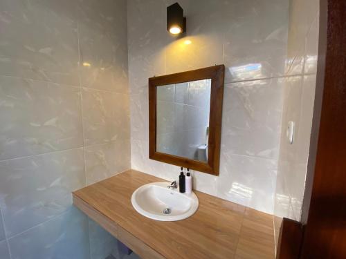 a bathroom with a sink and a mirror at Pattri Dihati Lembongan in Nusa Lembongan