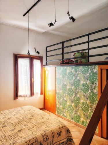 a bedroom with a bed and a large wall at Sarika House in Mestre