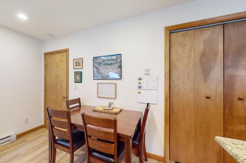 a dining room with a wooden table and chairs at Whispering Pines 323 in Durango