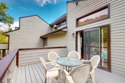 a patio with a table and chairs on a deck at Whispering Pines 323 in Durango