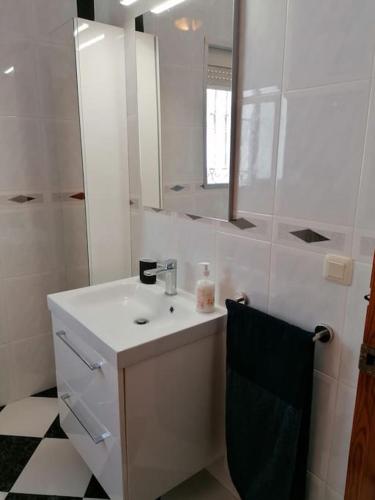 a white bathroom with a sink and a mirror at CASA PACO - Maison Andalousie in Cútar