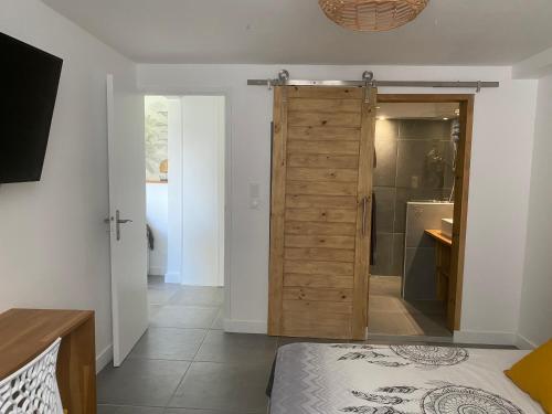 a bedroom with a door leading to a shower at Le 35 Anse des Rochers Saint-François in Saint-François