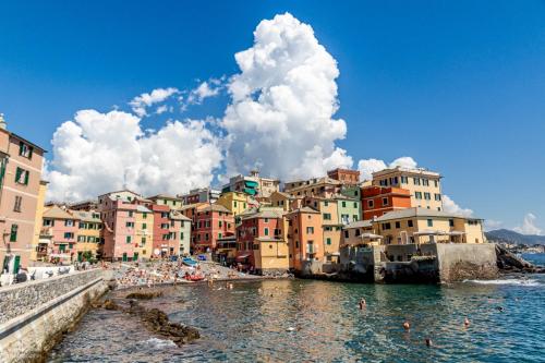 a group of buildings on a beach next to the water at MOONLIGHT IN BOCCADASSE (cod.Citra:010025-LT-2349) in Genova