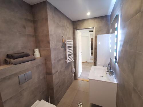 a bathroom with a toilet and a sink at Vytauto 422 Apartments by JK in Palanga