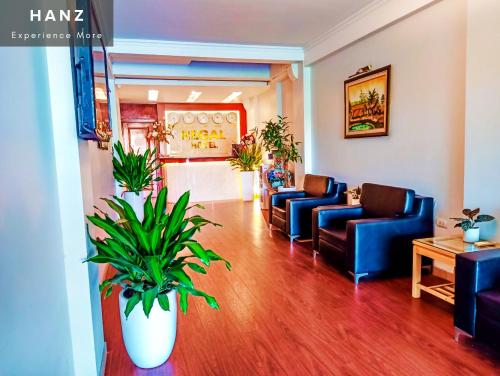 a waiting room with blue couches and potted plants at HANZ Regal Hotel Hanoi in Hanoi