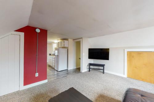 a living room with a red wall and a red door at East End Annex in Portland