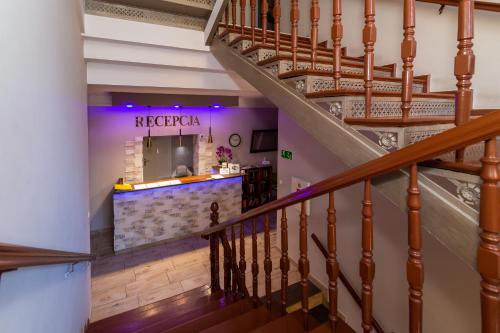 a staircase leading up to a restaurant with a counter at Willa Diament in Kudowa-Zdrój