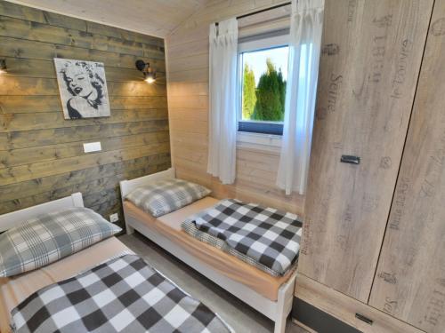 a room with two beds and a window in it at Year-round cottage for 2 people, Ustronie Morskie in Ustronie Morskie