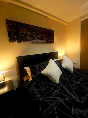 a bedroom with a bed with two pillows on it at Nottingham city view apartment in Nottingham