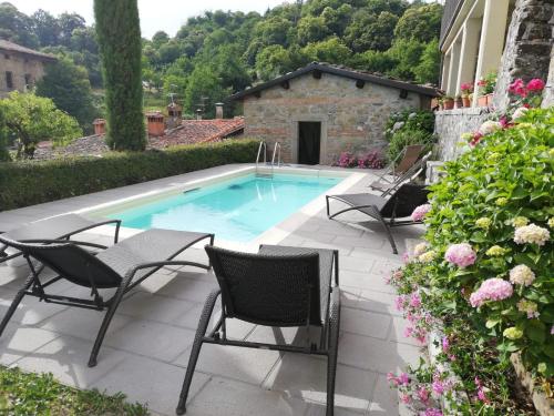 a patio with chairs and a swimming pool at Apartment Casa Gianfrati in Corfino