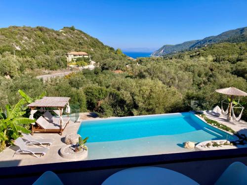 a swimming pool with a view of a mountain at Ninfas del Mar in Agios Nikitas