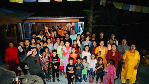 a large group of people posing for a picture at Joy Source Resort in Kathmandu