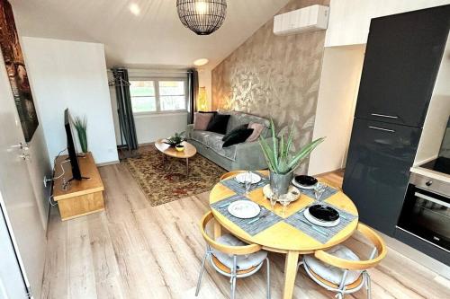 a living room with a table and a couch at Le Campagnard & Le Maryline # Wifi # Clim # Parking Gratuit # Calme & Nature in Marboz
