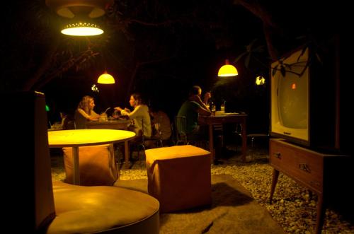 a group of people sitting at tables in a restaurant at Posada IRSIS in La Pedrera
