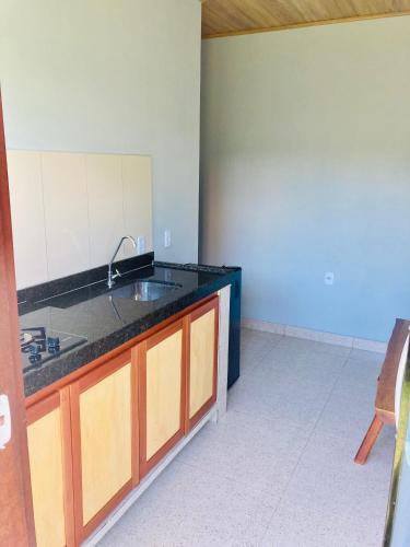 a kitchen with a sink and a counter top at Portuá Chalés in São Miguel dos Milagres