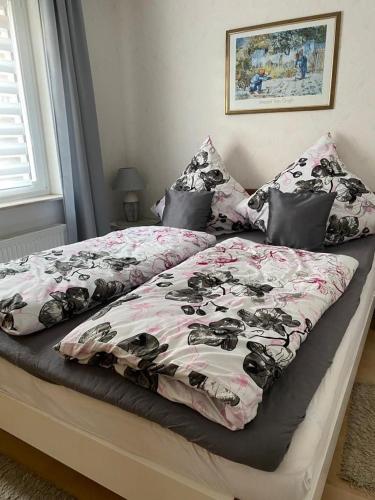 a bed with a dog comforter and pillows on it at Ferienwohnung Gossel in Bad Wildungen
