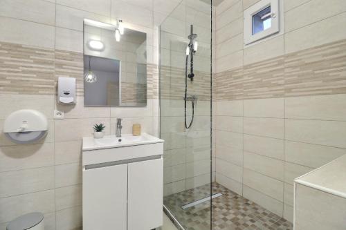 a white bathroom with a shower and a sink at Chambre cosy jo in Saint-Alban