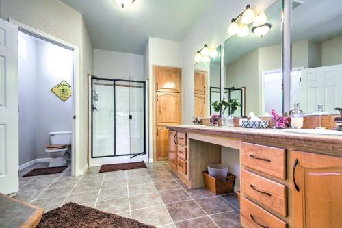 a bathroom with a sink and a toilet and a mirror at Beautiful Kanab Home with Yard - Walk to Restaurants in Kanab