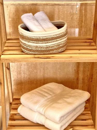 two towels are sitting on a wooden shelf at Il Lago Incantato in Lonato del Garda